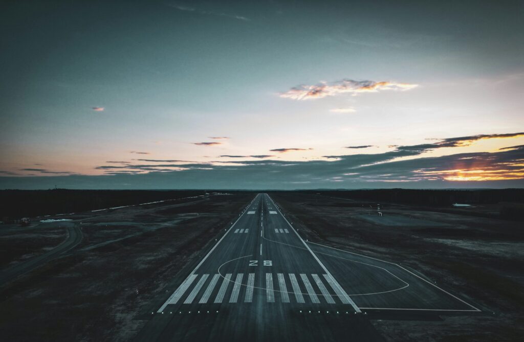 an aerial view of an airport runway at sunset