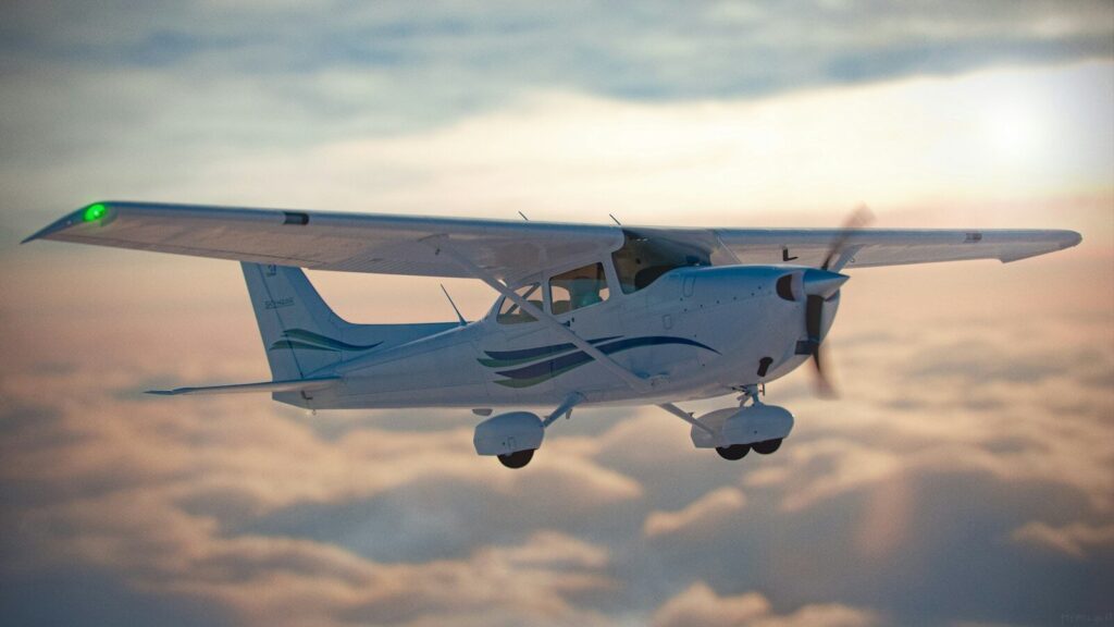 a small airplane flying through a cloudy sky
