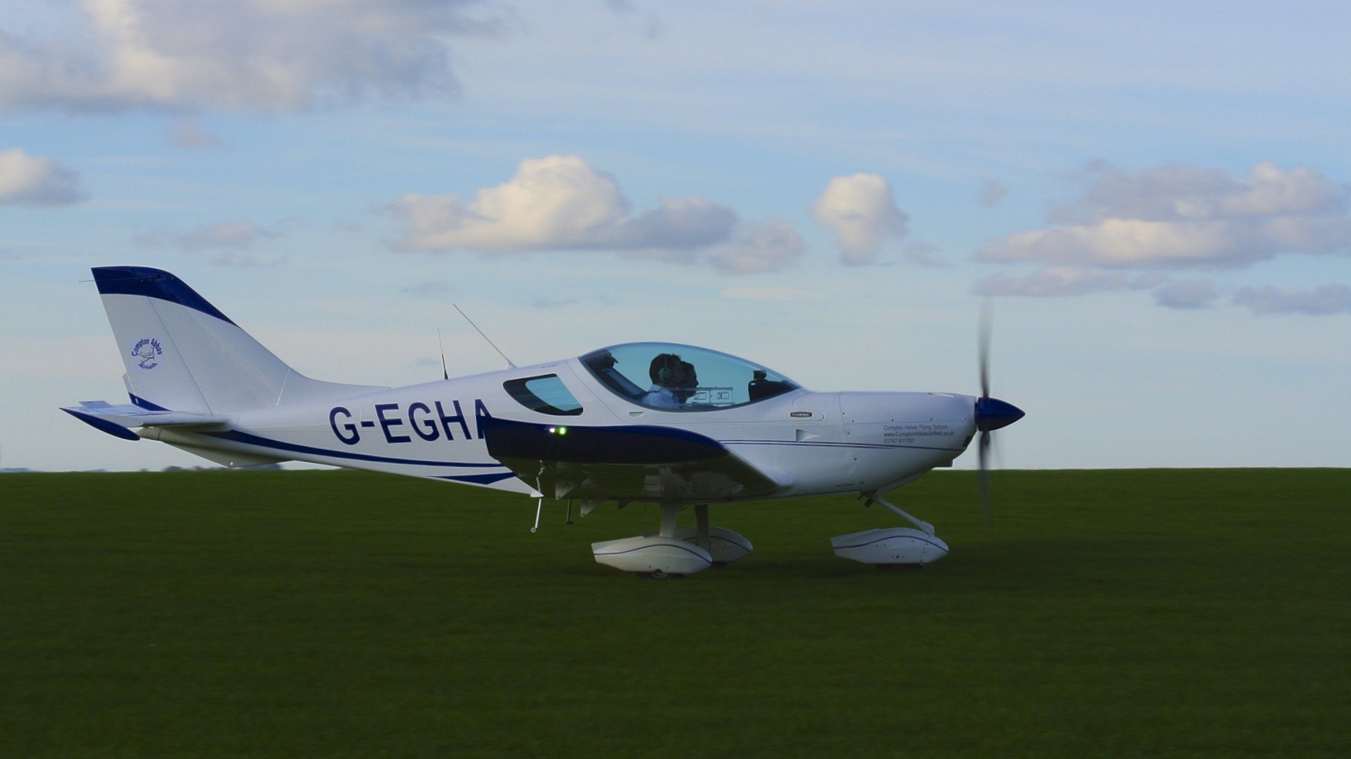 Modern light sport aircraft (SportCruiser) on a grass airfield