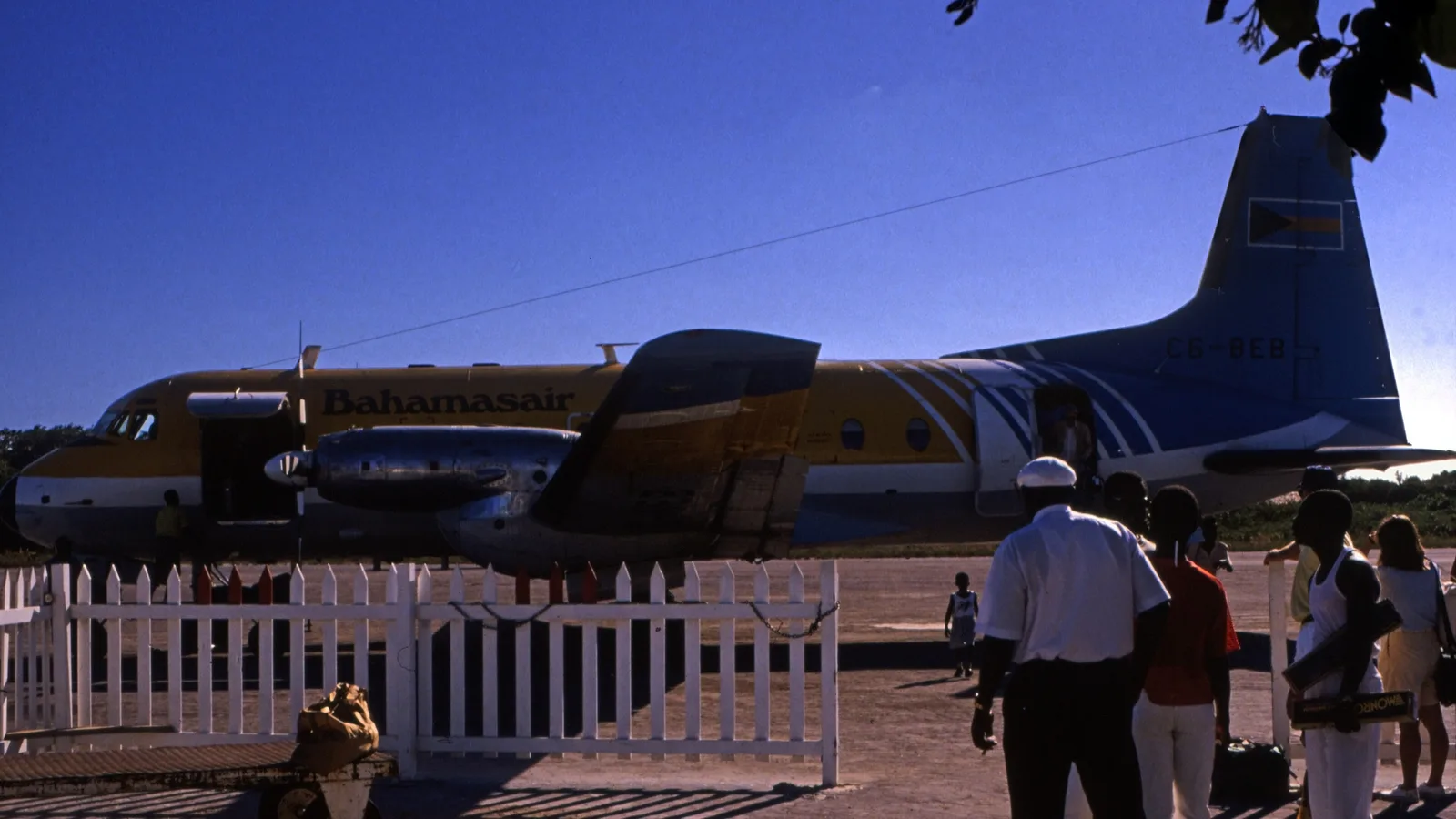 Passengers waiting by a Bahamasair Hawker Siddeley 748 at George Town Airport on Great Exuma, Bahamas, in 1989