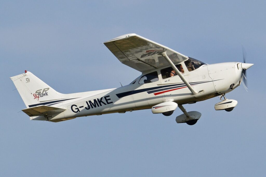 White Cessna 172S Skyhawk G-JMKE climbing away after take-off against a clear blue sky