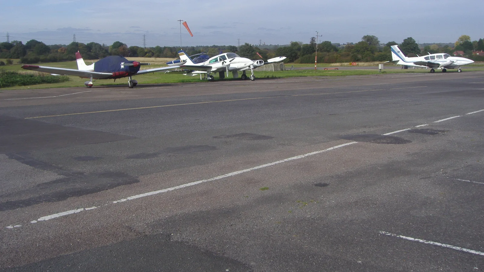 Light aircraft parked beside the runway at Elstree Aerodrome, north of London