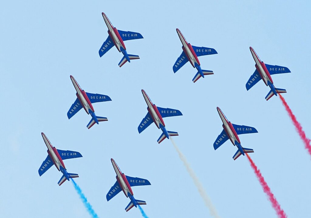 Patrouille de France jets in diamond formation trailing red, white and blue smoke at the Paris Air Show