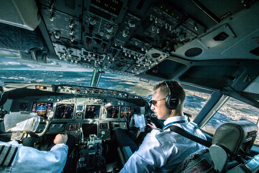 Pilot Careers Live London – image Airline pilot at the controls in a jet cockpit, view through the windscreen
