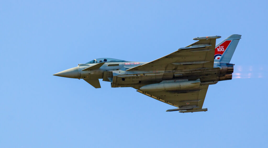 RAF Eurofighter Typhoon display jet in RAF 100 livery against a clear blue sky